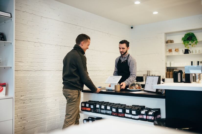 man buying coffee in a coffee shop